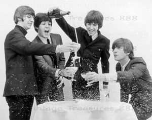 The Beatles celebrate with champagne